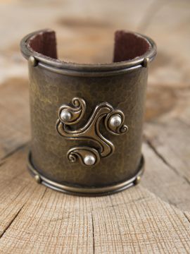 Wide brass bangle with Celtic triskele