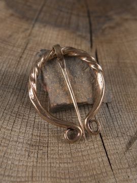 Omega brooch turned from bronze