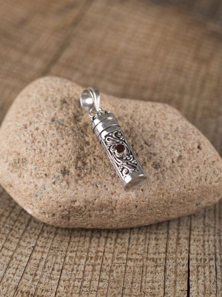 Opening medallion vial in silver with garnet